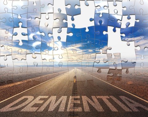 A puzzle with "dementia" written on the road and pieces missing.